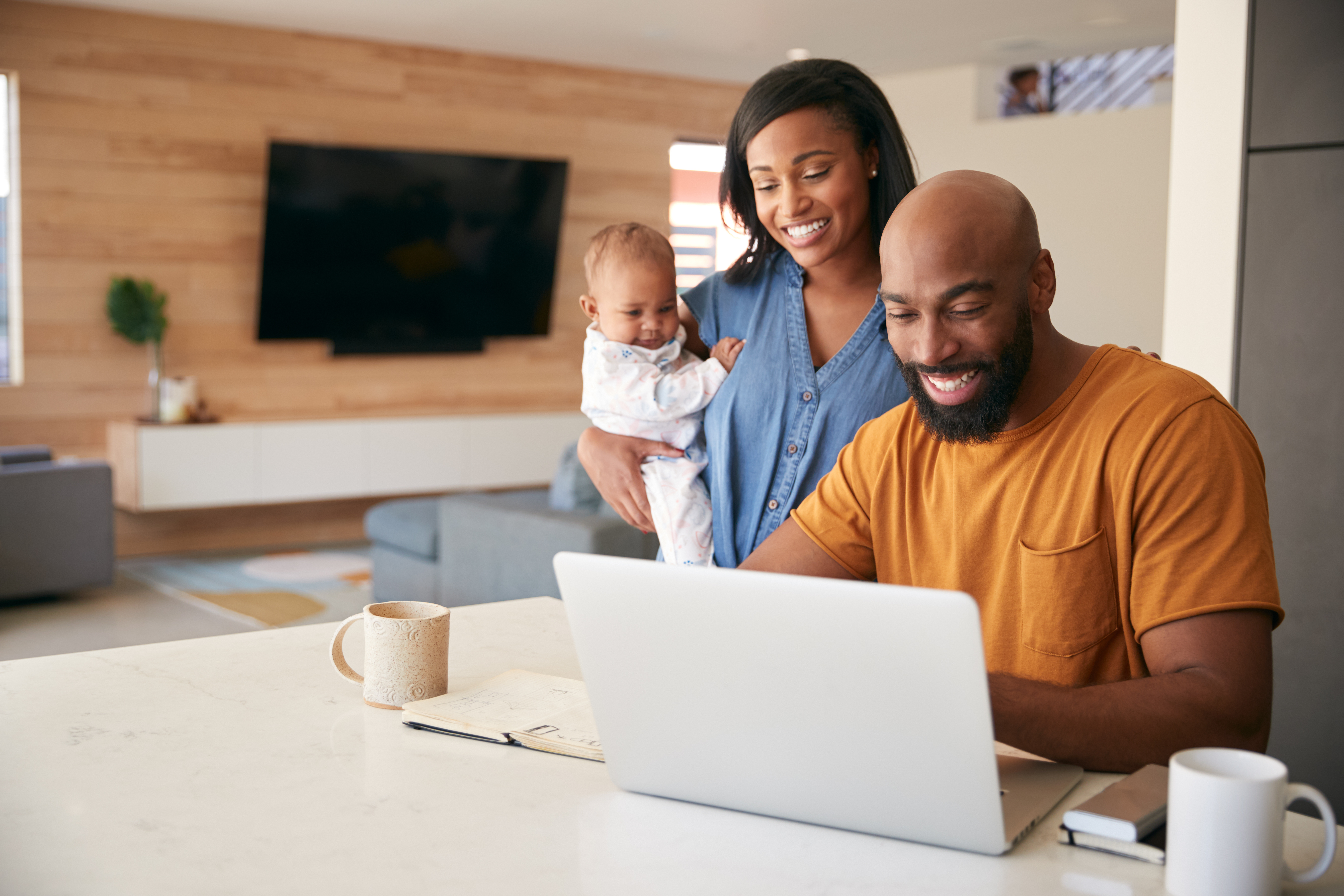 Man and women with baby looking at computer