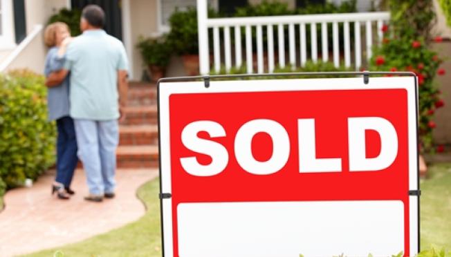 sold sign in front of home