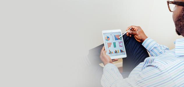 man viewing graphs on tablet