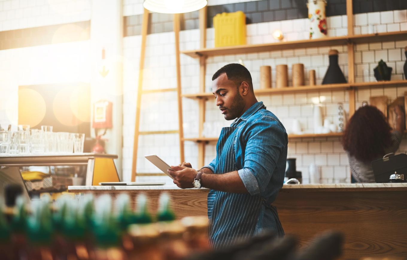 Restaurant owner looking at tablet