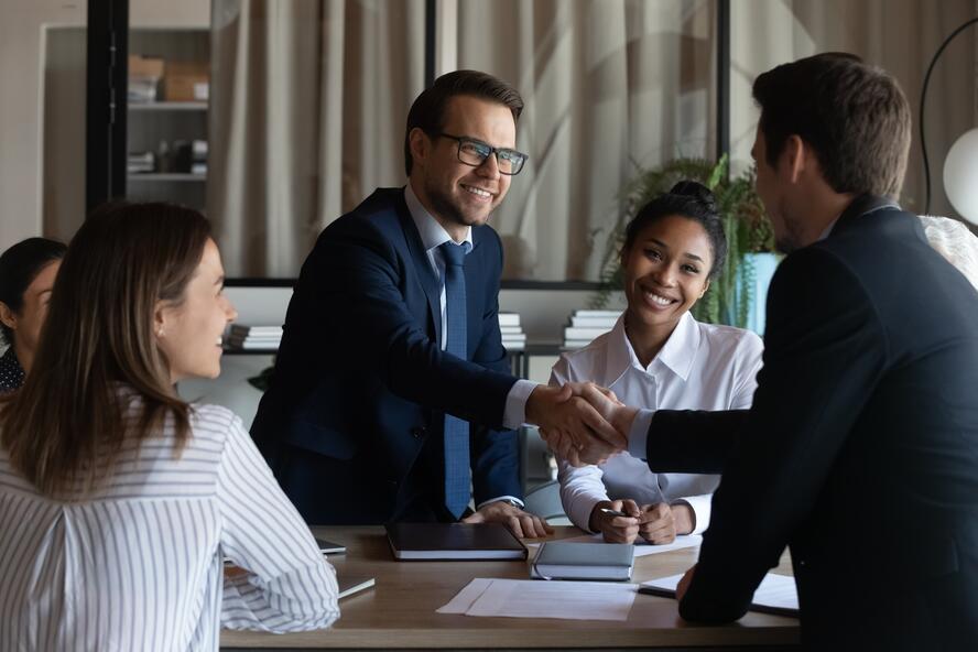Business men shaking hands during meet