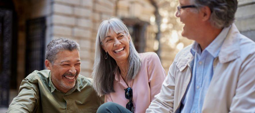 Three senior friends laughing together