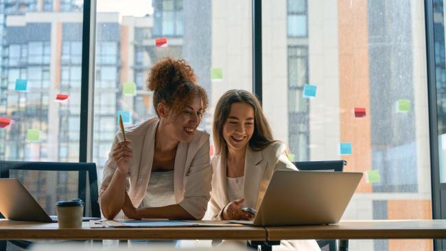 Business women looking at laptop in office