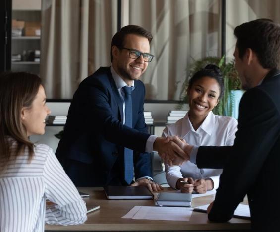 Business men shaking hands during meet