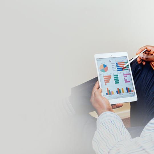 man viewing graphs on tablet